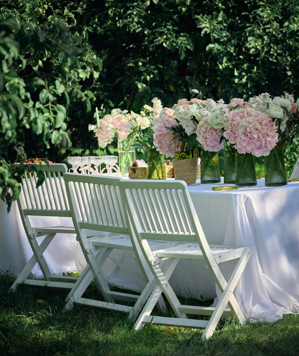 A garden table set with peonies